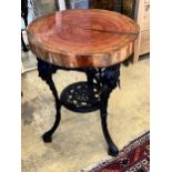 A resin encased cedar wood occasional table with cast iron underframe, diameter 53cm