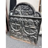 A cast iron fireback, bearing date 1588 and decorated with twin anchors, width 55cm, height 66cm