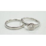 A modern platinum and collet set solitaire diamond ring, size M, gross weight 4.9 grams, together