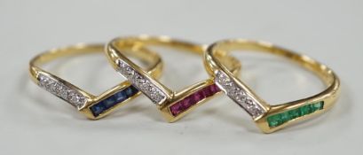 A set of three 750, sapphire, emerald and diamond set wishbone rings, (to be worn as one or
