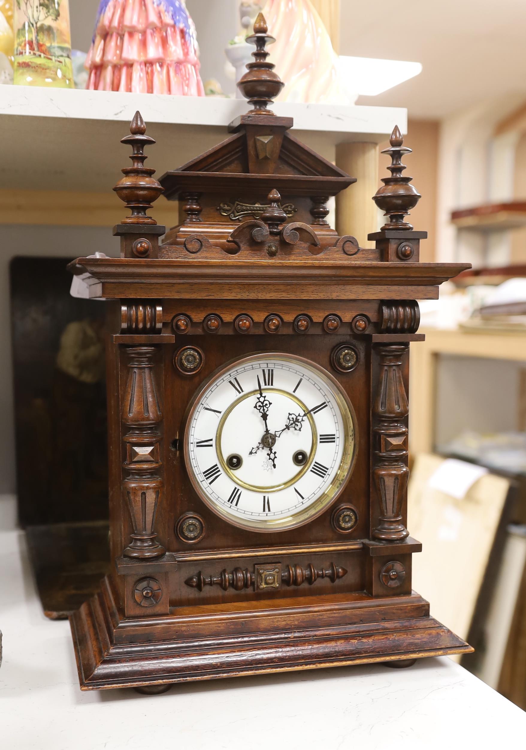 A late 19th century German carved and turned mahogany mantel clock, 56cm high