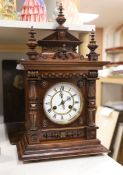 A late 19th century German carved and turned mahogany mantel clock, 56cm high