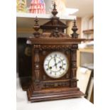 A late 19th century German carved and turned mahogany mantel clock, 56cm high