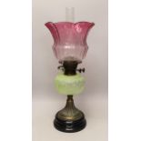 A Victorian brass and glass oil lamp, with cranberry shade, 58cm high including funnel