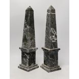 A pair of black and white variegated marble obelisks, 48cm