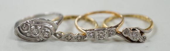 Two 18ct, plat and illusion set three stone diamond rings and two other similar white metal rings,