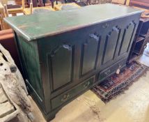 An 18th century panelled and painted oak mule chest with later green paintwork, width 150cm,