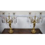 A pair of Regency ormolu ‘Cupid’ two branch glass lustre candelabra, 37cm high