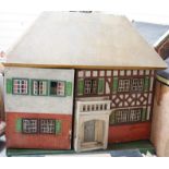 A Tri-ang dolls’ house, mid 20th century, with a rough cast facade, a section of half-timbering