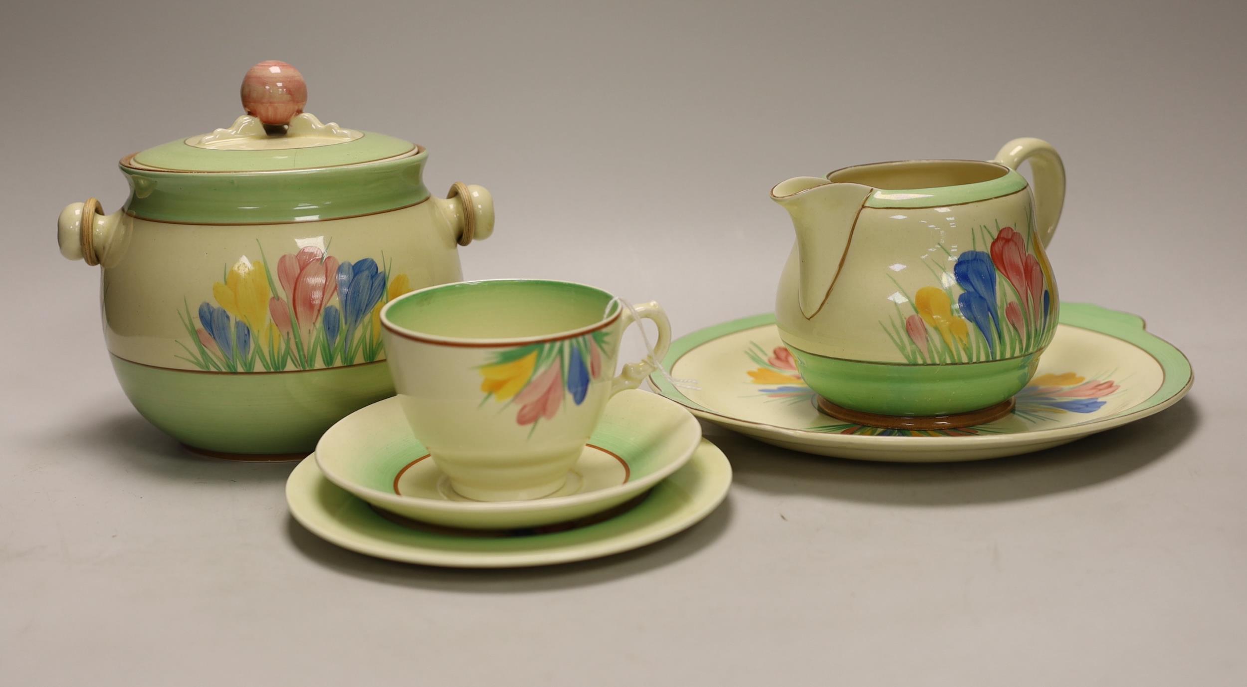 Clarice Cliff ‘Spring Crocus’: a trio, a cake plate, a jug and a biscuit barrel and cover, 17cm high