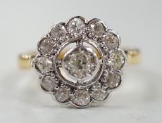 An 18ct and illusion set diamond circular cluster ring, size N, gross weight 5.1 grams.