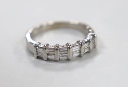 A modern 18ct white gold and two row baguette cut diamond cluster set half hoop ring, size P/Q,