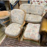 An Ercol elm three piece suite comprising settee, armchair and footstool