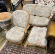 An Ercol elm three piece suite comprising settee, armchair and footstool