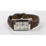 A gentleman's modern stainless steel Alfred Dunhill manual wind rectangular wrist watch, on a