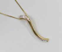 A modern 18ct gold and diamond chip 'S' shaped pendant, 38mm, on an 18ct gold chain, 39cm, gross