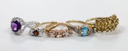 Five assorted modern 9ct gold and gem set rings including a white gold, amethyst and diamond ring,
