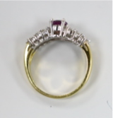 A modern 18ct gold and single stone oval cut garnet? dress ring, with two row diamond set shoulders, - Image 3 of 3