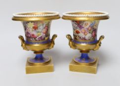 A pair of Minton twin handled urn form vases, hand painted with floral motifs, in the style of