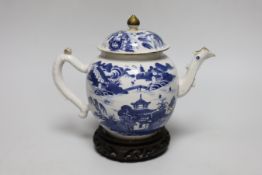 An 18th century Chinese blue and white teapot and cover, with hardwood stand, 19cm total height