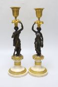 A pair of early 20th century bronze, ormolu and alabaster figural candlesticks, 33cm
