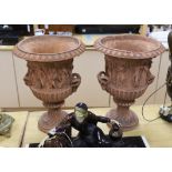 A pair of terracotta neo classical urns, 46cm