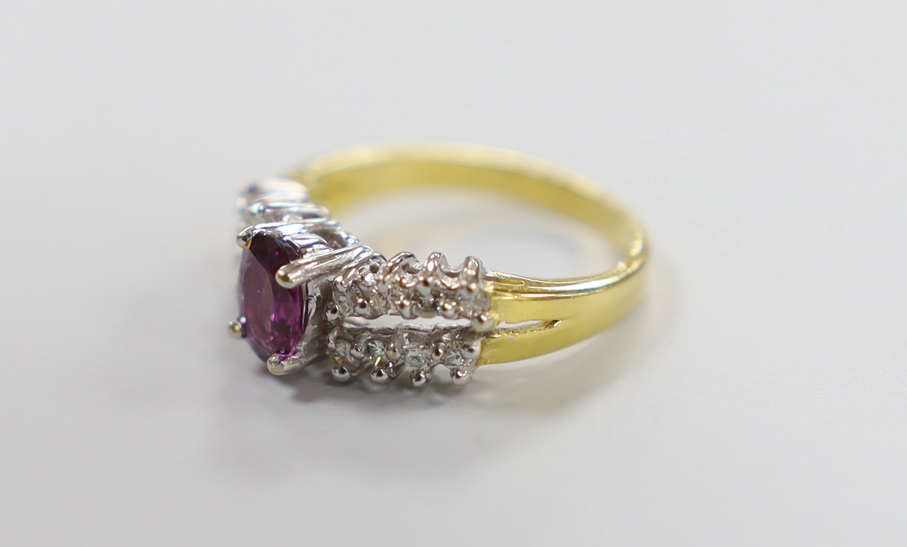 A modern 18ct gold and single stone oval cut garnet? dress ring, with two row diamond set shoulders, - Image 2 of 3