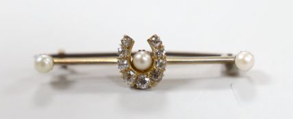 An Edwardian 15ct, diamond and seed pearl set horse shoe bar brooch, 40mm, gross weight 3.2 grams.