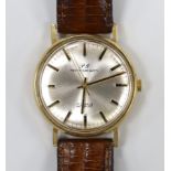 A gentleman's yellow metal Perry Greaves manual wind wrist watch, with case back inscription.