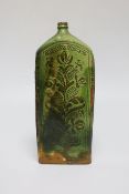 A 19th century green glazed terracotta Sgraffito flask, 19cm