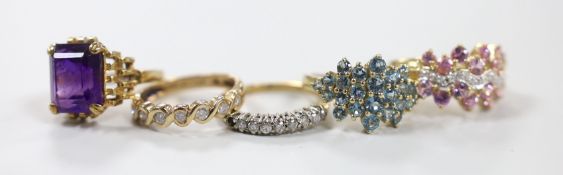 Five assorted modern 9ct gold and gem set rings, including two diamond set half hoop, gross weight