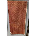 A late 19th early 20th century Fez embroidered table runner, with an all over rust silk design,