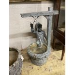 A cast metal garden bird bath modelled as a boy at a well, height 79cm