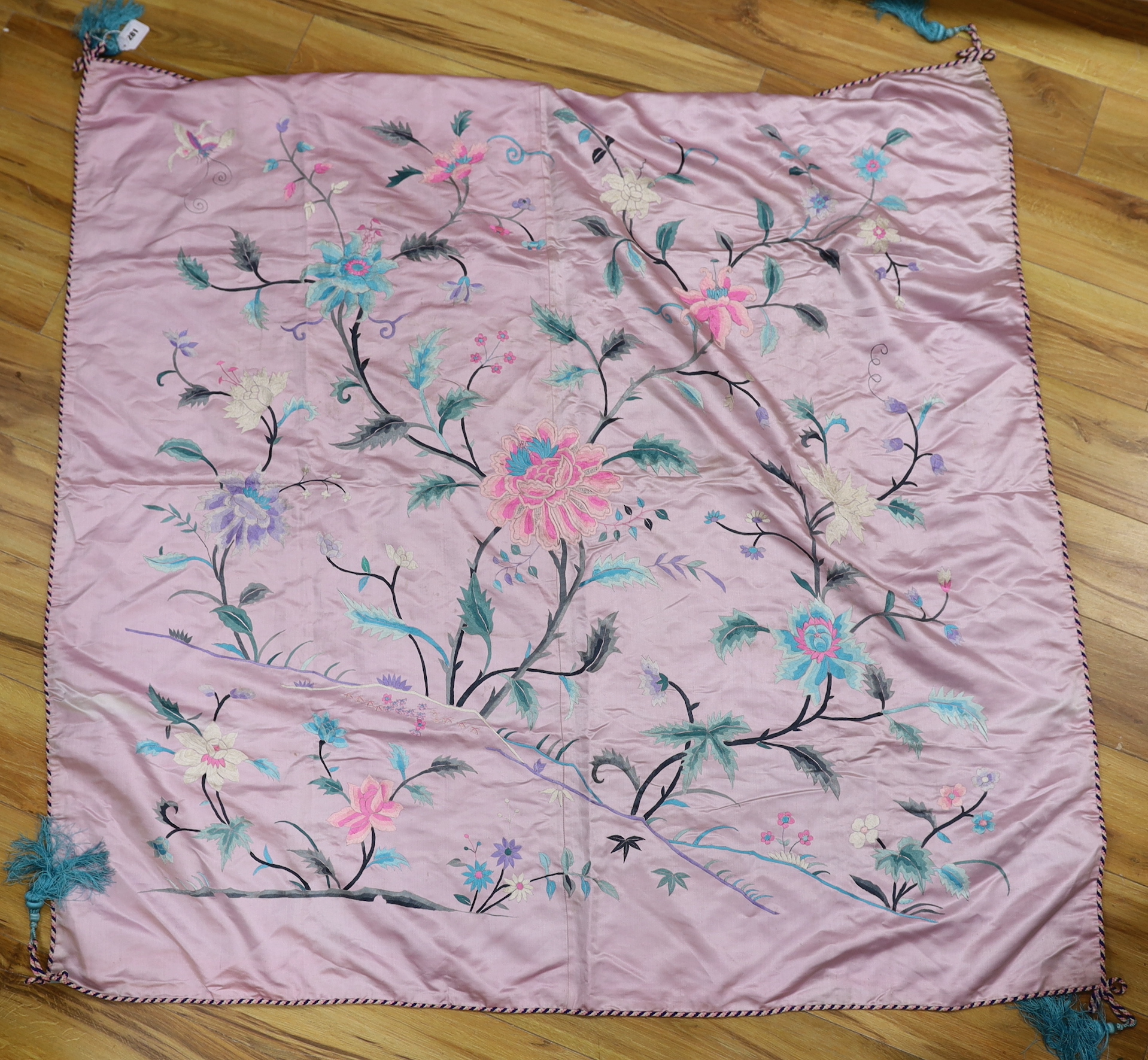 An Oriental mauve ground embroidered silk shawl