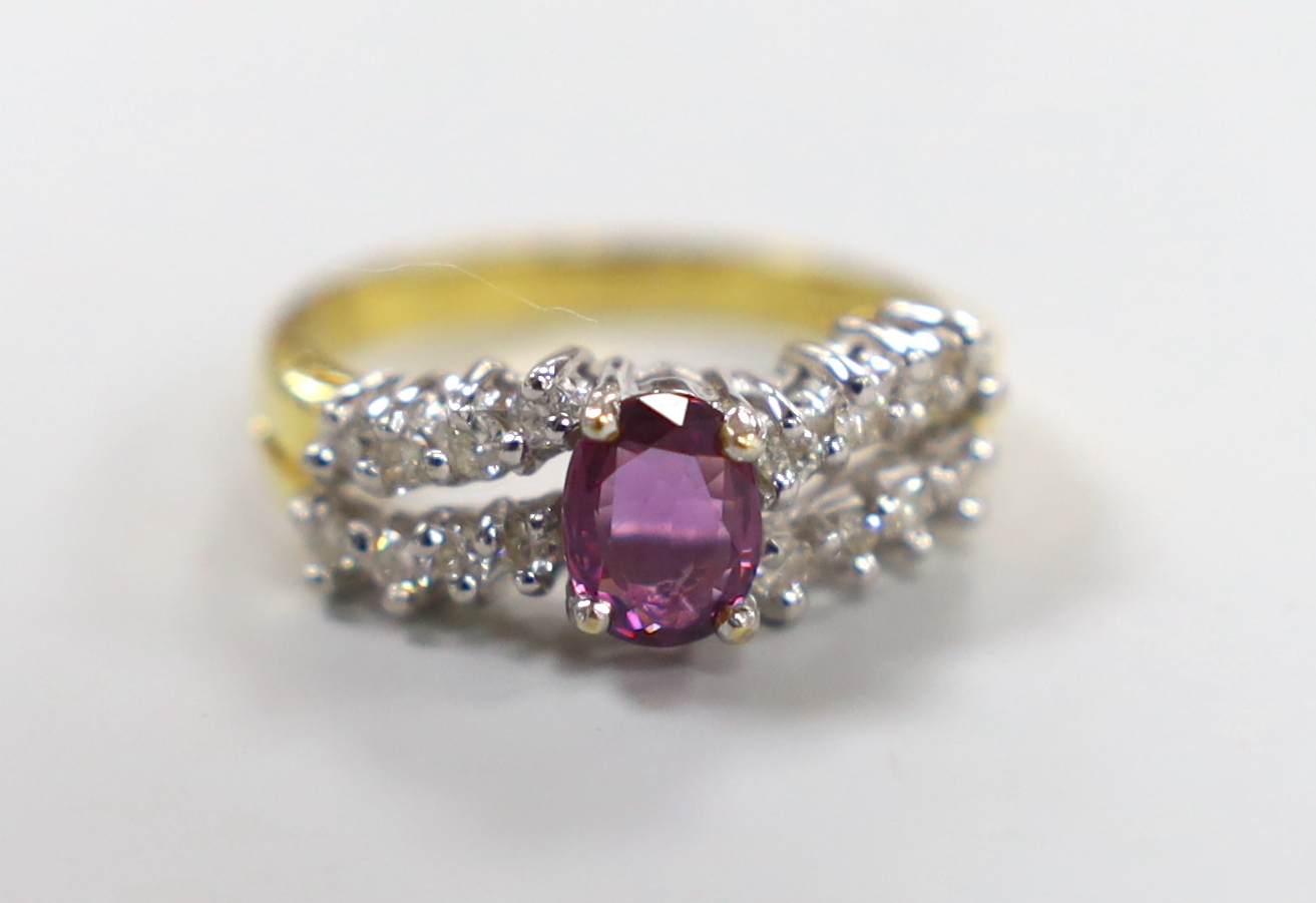 A modern 18ct gold and single stone oval cut garnet? dress ring, with two row diamond set shoulders,