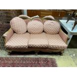 An early 20th century faded mahogany three piece suite, settee length 163cm, depth 85cm, height