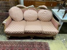 An early 20th century faded mahogany three piece suite, settee length 163cm, depth 85cm, height