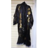 A 20th century Japanese black silk satin kimono, embroidered with thick gold coloured dragons