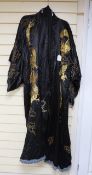 A 20th century Japanese black silk satin kimono, embroidered with thick gold coloured dragons