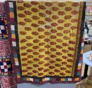 An Indian early 20th century multicoloured fabric quilt, with an embroidered central panel and