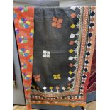 An early 20th century Indian multicoloured patchwork quilt, worked with a black central panel and