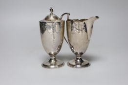A George V chased silver cream jug and matching sugar caster, Collingwood & Sons Ltd, Birmingham,