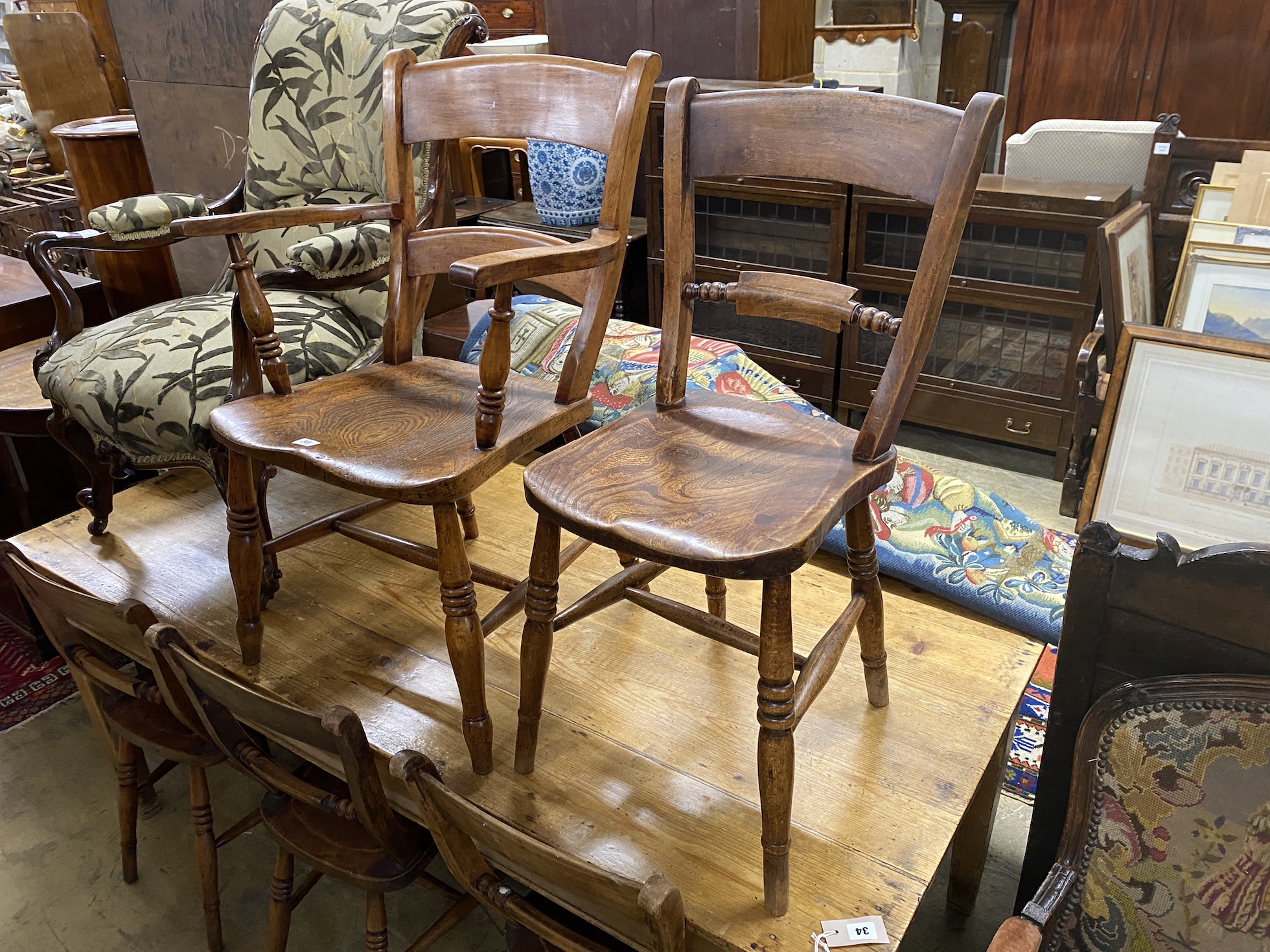 A harlequin set of seven Victorian elm and beech Windsor chairs, (one with arms)