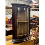 A reproduction George III style glazed mahogany bowfront hanging corner cupboard, width 49cm,