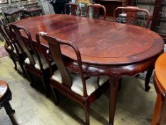 A Chinese hardwood extending dining table, length 244cm extended, two spare leaves, width 110cm,