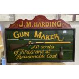 A reproduction painted wood 'Gunmaker' sign, width 90cm, height 61cm