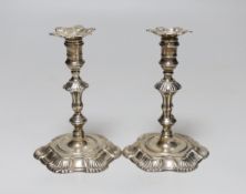 A pair of George II cast silver taper sticks, with unmarked nozzles, by John Cafe, London 1749/1750,