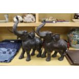 A pair of decorative bronze trumpeting elephants. 57cm tall