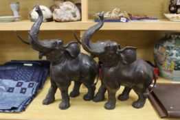A pair of decorative bronze trumpeting elephants. 57cm tall