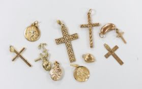Three modern 9ct gold cross pendants, largest 34mm, a 9ct gold bean charm and St. Christopher